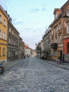 Warsaw Old Town Street, father and daughter riding bicycles